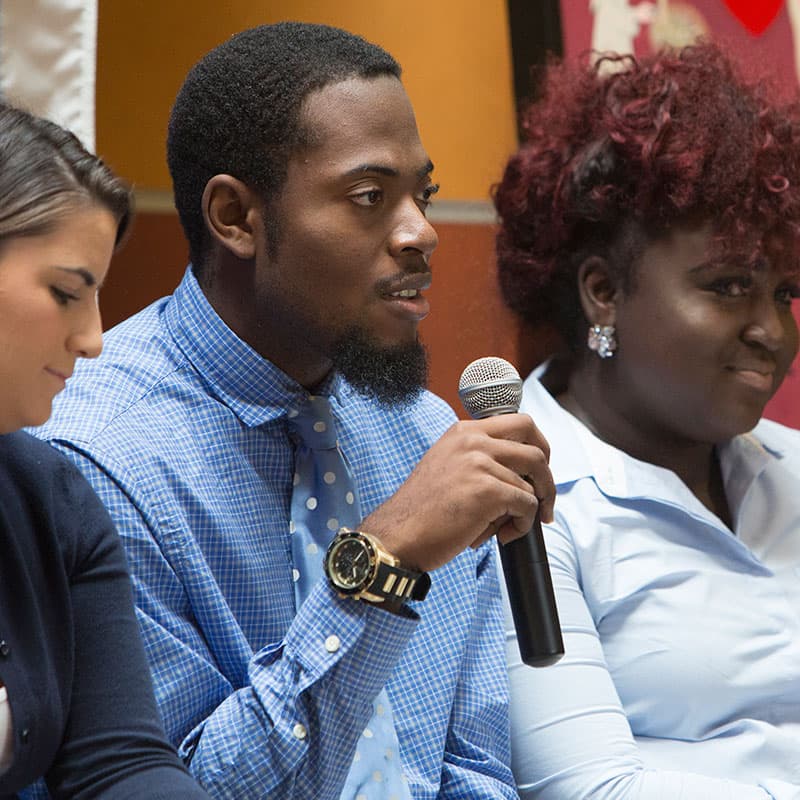 Kobey Smith '20, speaking at Founder's Day about his team's community service project at Albertus Magnus College