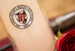 candle and Albertus logo with a rose