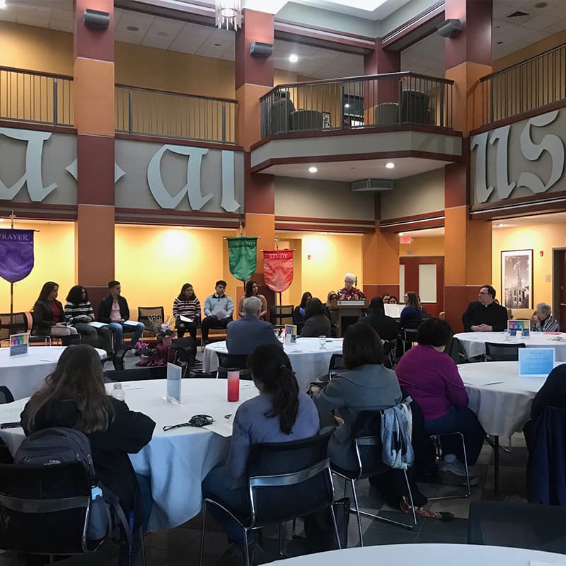 The audience gathers for the panel discussion in the Atrium of the Tagliatela Academic Center