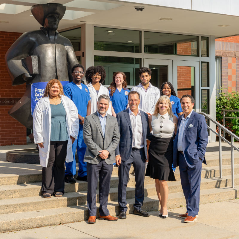 group photo of students, President of Albertus Magnus College, Vice President of Advancement, and Luke and Stephanie Williams
